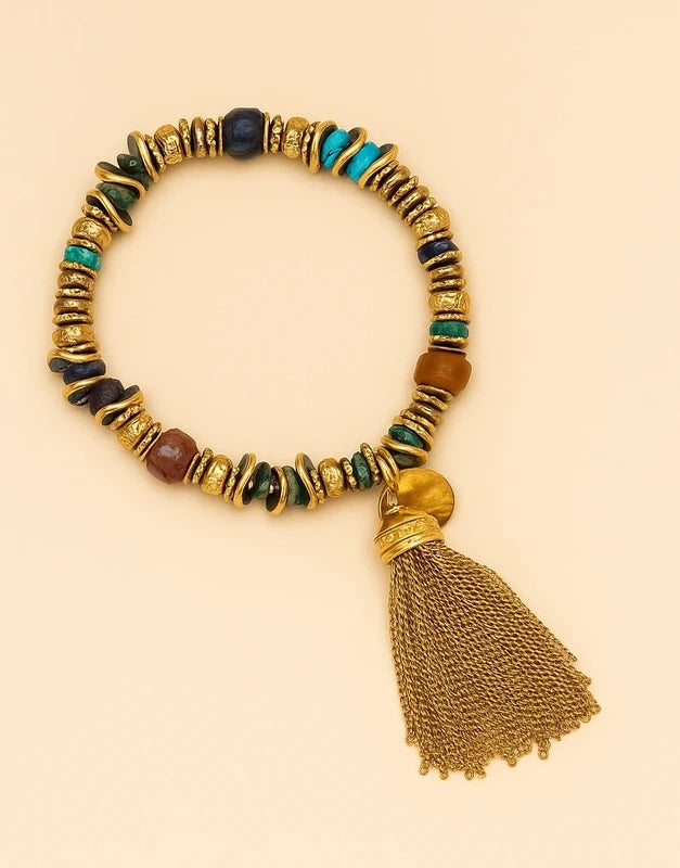 Bracelet élastique en pierre naturelles et acier inoxydable avec pompon excellent état.